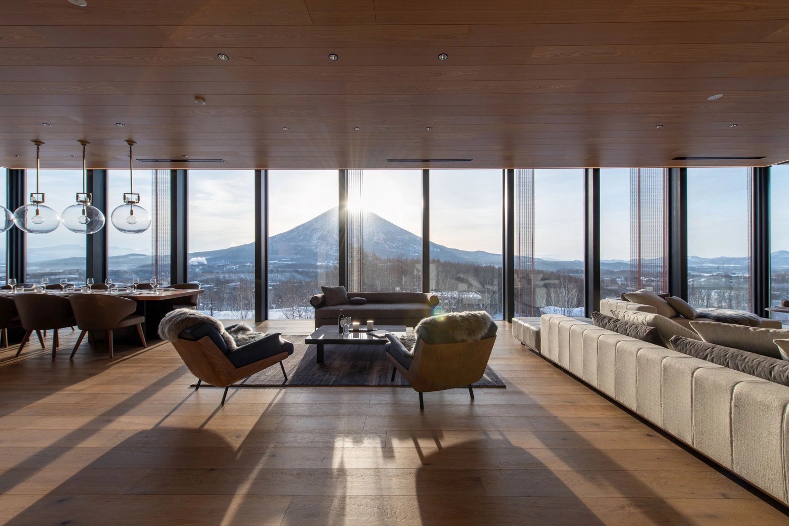 Mount Yōtei seen across the Niseko valley from a property balcony, the cone most rooms here are priced on